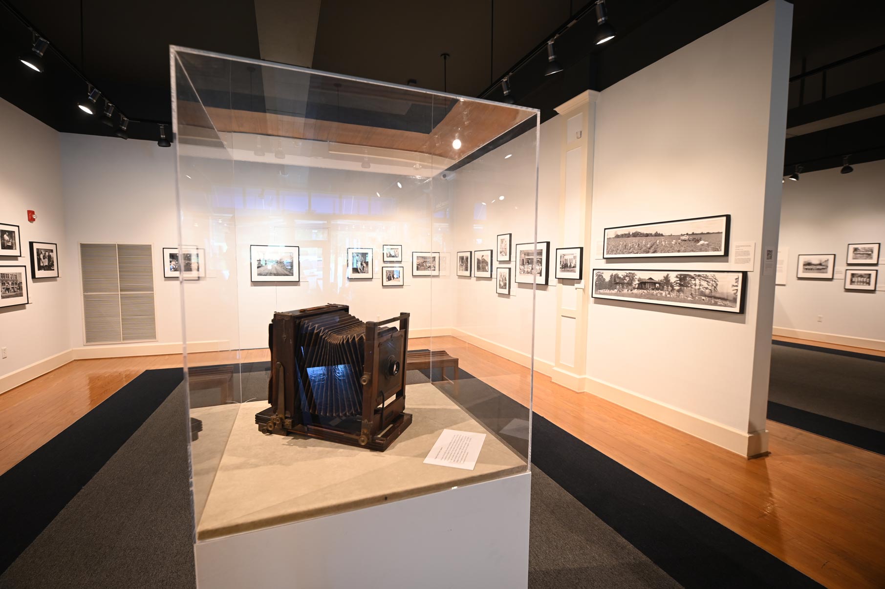 Exhibit room at Delta Cultural Center with an old accordion-like camera in the center.